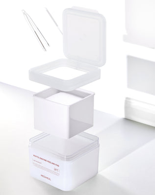 White cosmetic container with lid on a white background